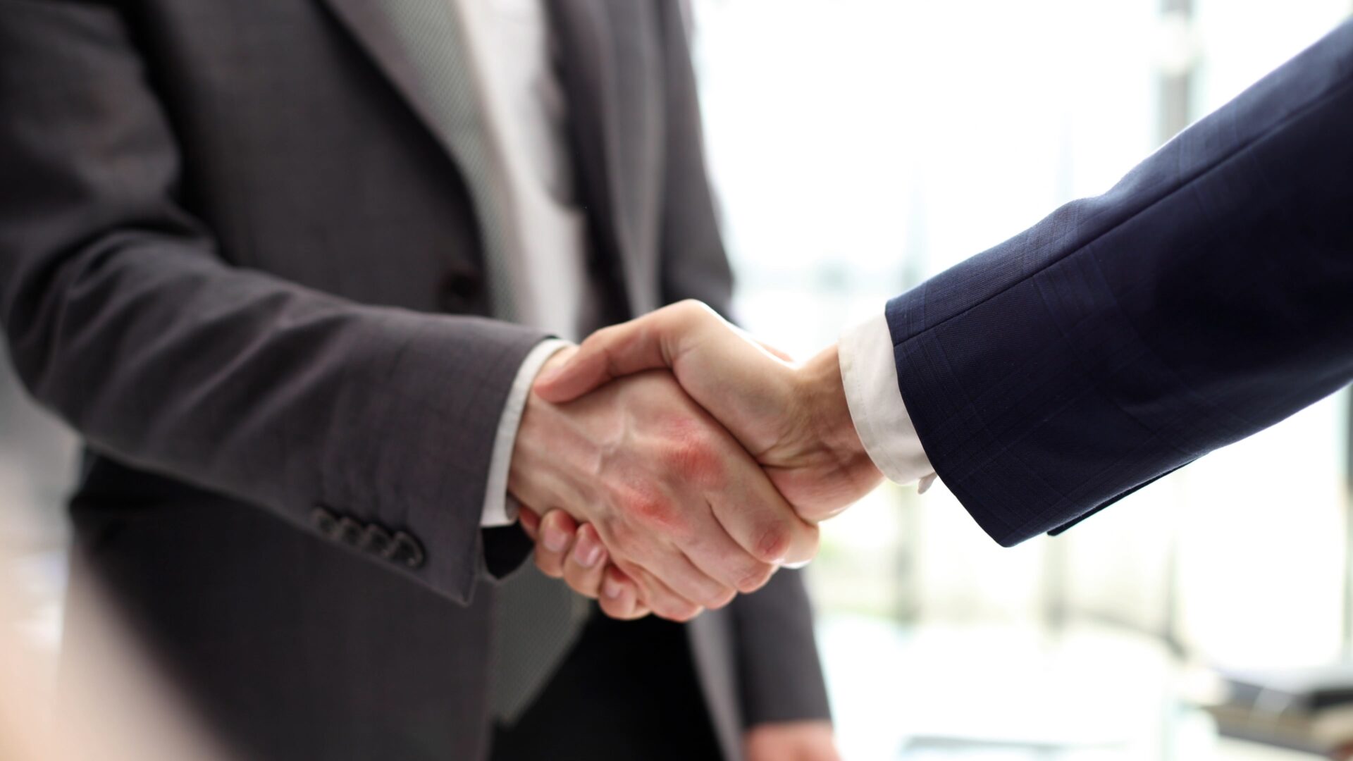 two men shaking hands after successful sale of accounting practice